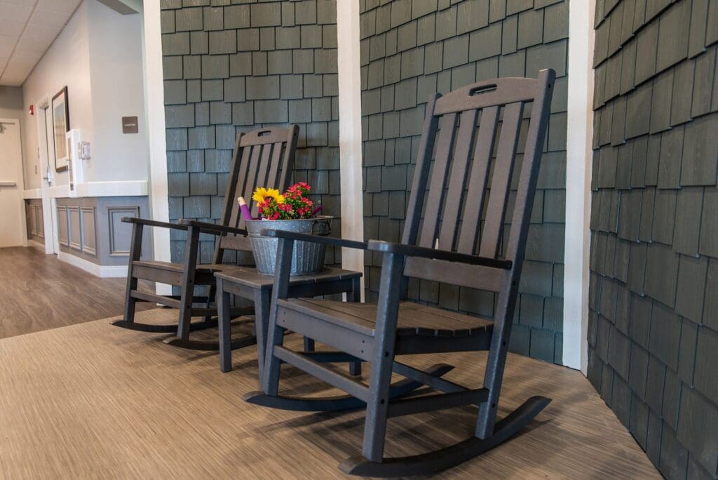 Charter Senior Living of Paducah rocking chairs next to green background